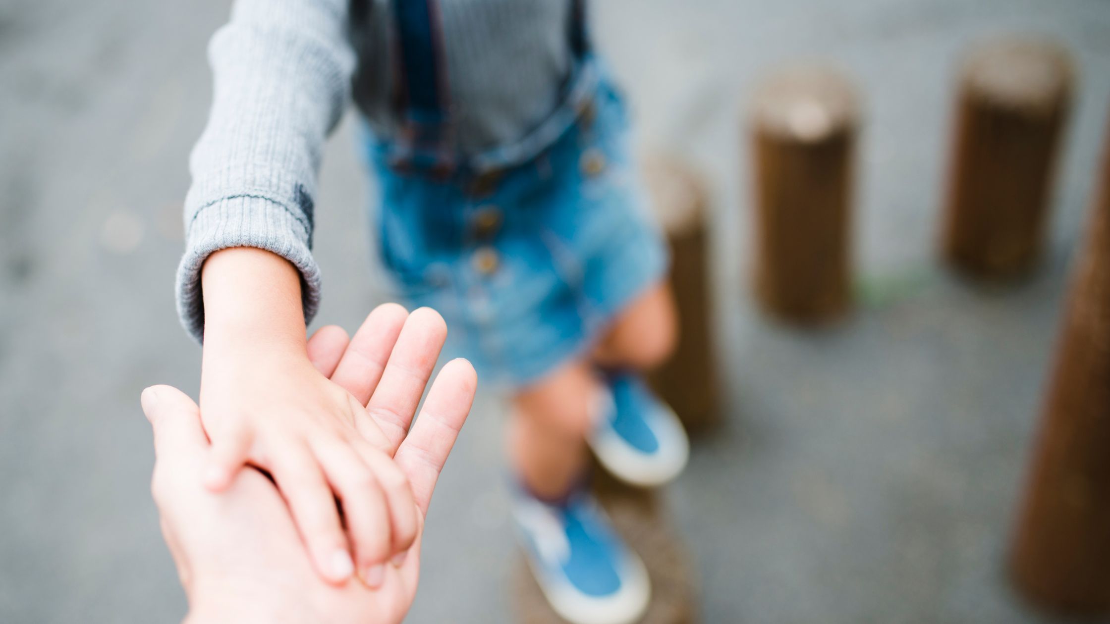 Parent reaching for child's hand Montessori Parents