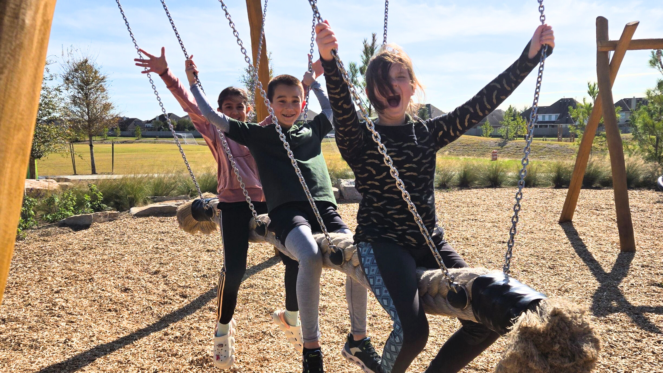 Children playing happily together on the playgrouund. Montessori students.